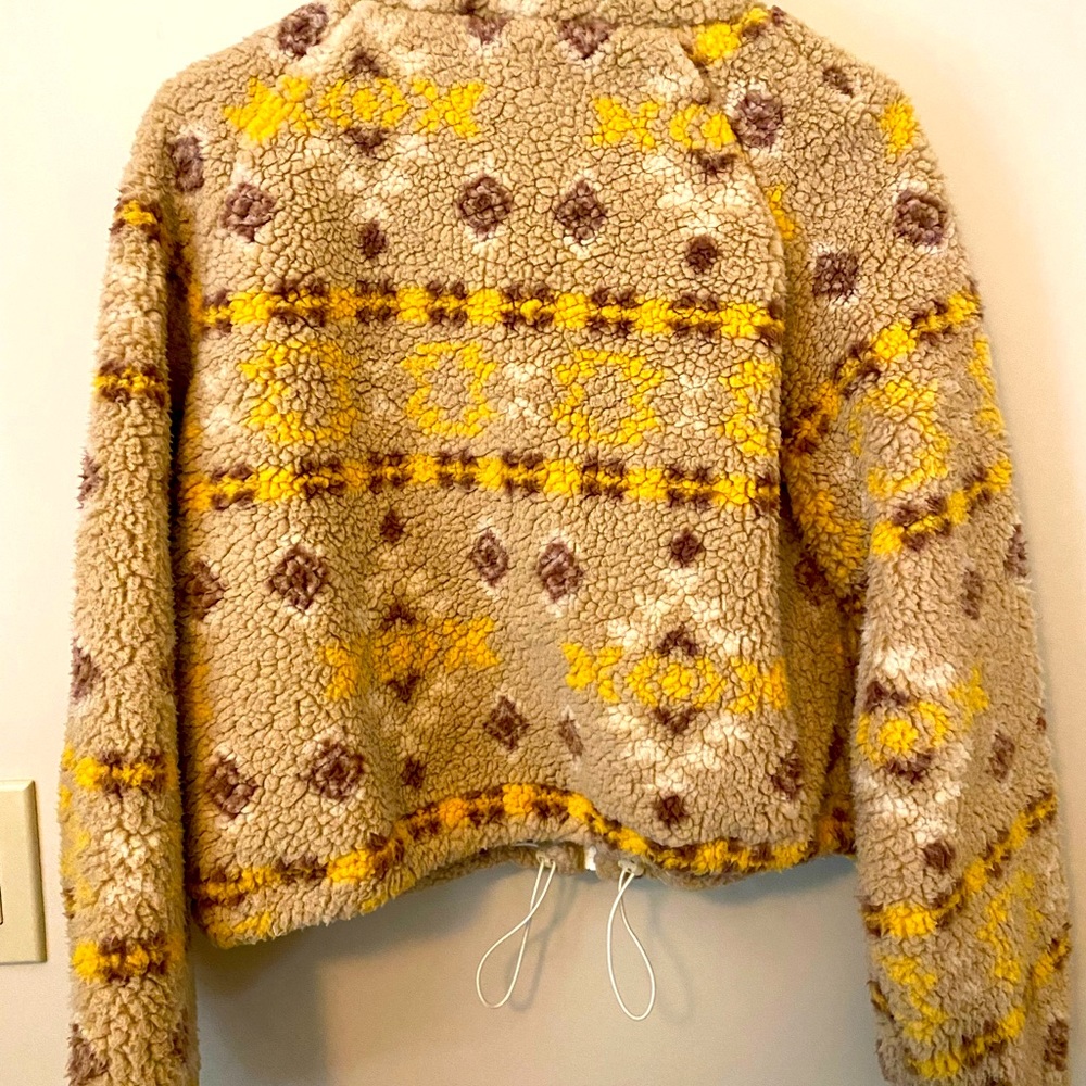 Soft and fuzzy shearling-like jacket that zips up . Fun to mix and match!